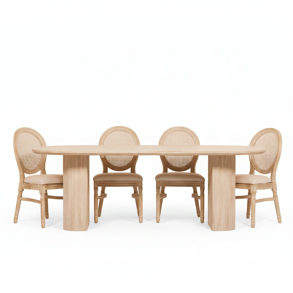 Dining room with a wooden table and chairs against a white paneled wall.