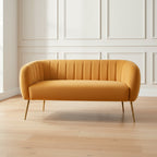 yellow sofa with golden legs and channel tufted upholstery